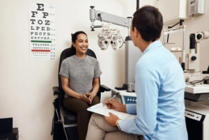 An eye care professional conducting a visual acuity test with a Snellen chart An eye care professional conducting a visual acuity test with a Snellen chart