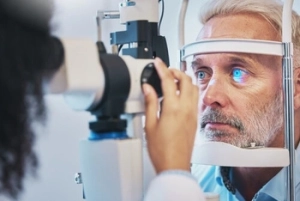 male patient undergoing an eye examination male patient undergoing an eye examination